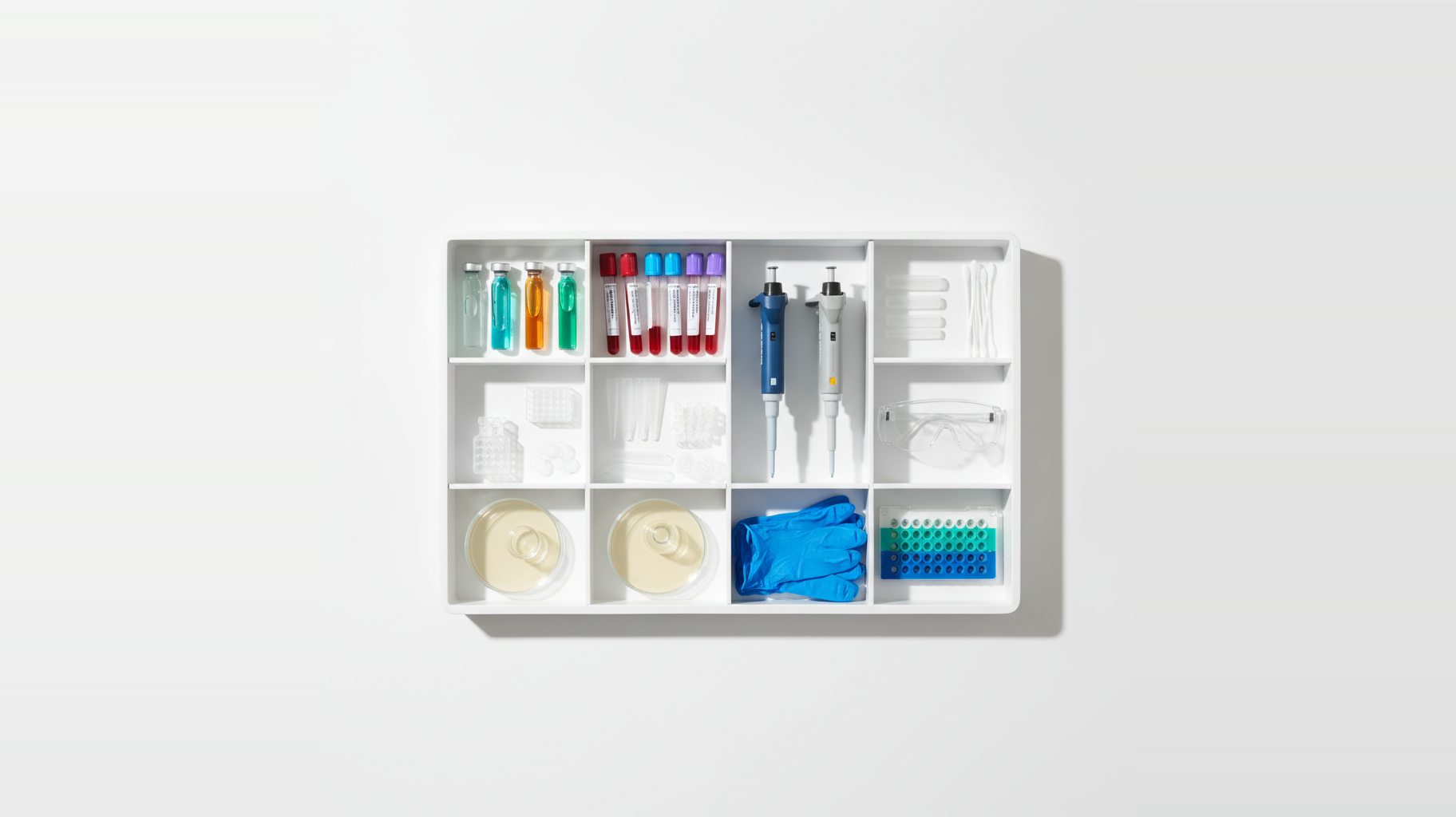 An organized laboratory storage cabinet with compartments holding collection tubes, reagent vials, pipettes, gloves, petri dishes, and microplates — representing the discrete supply categories a clinical lab manages